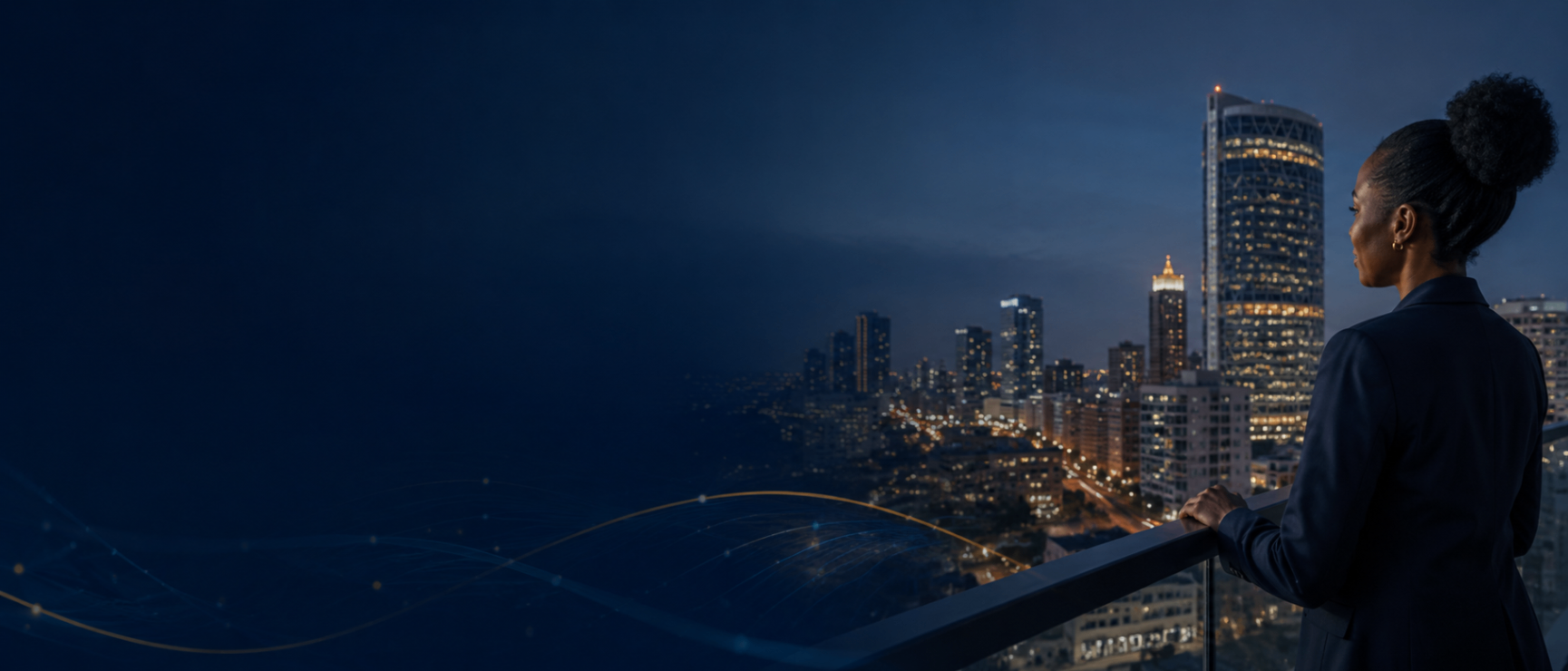 Business owner overlooking a city skyline at night